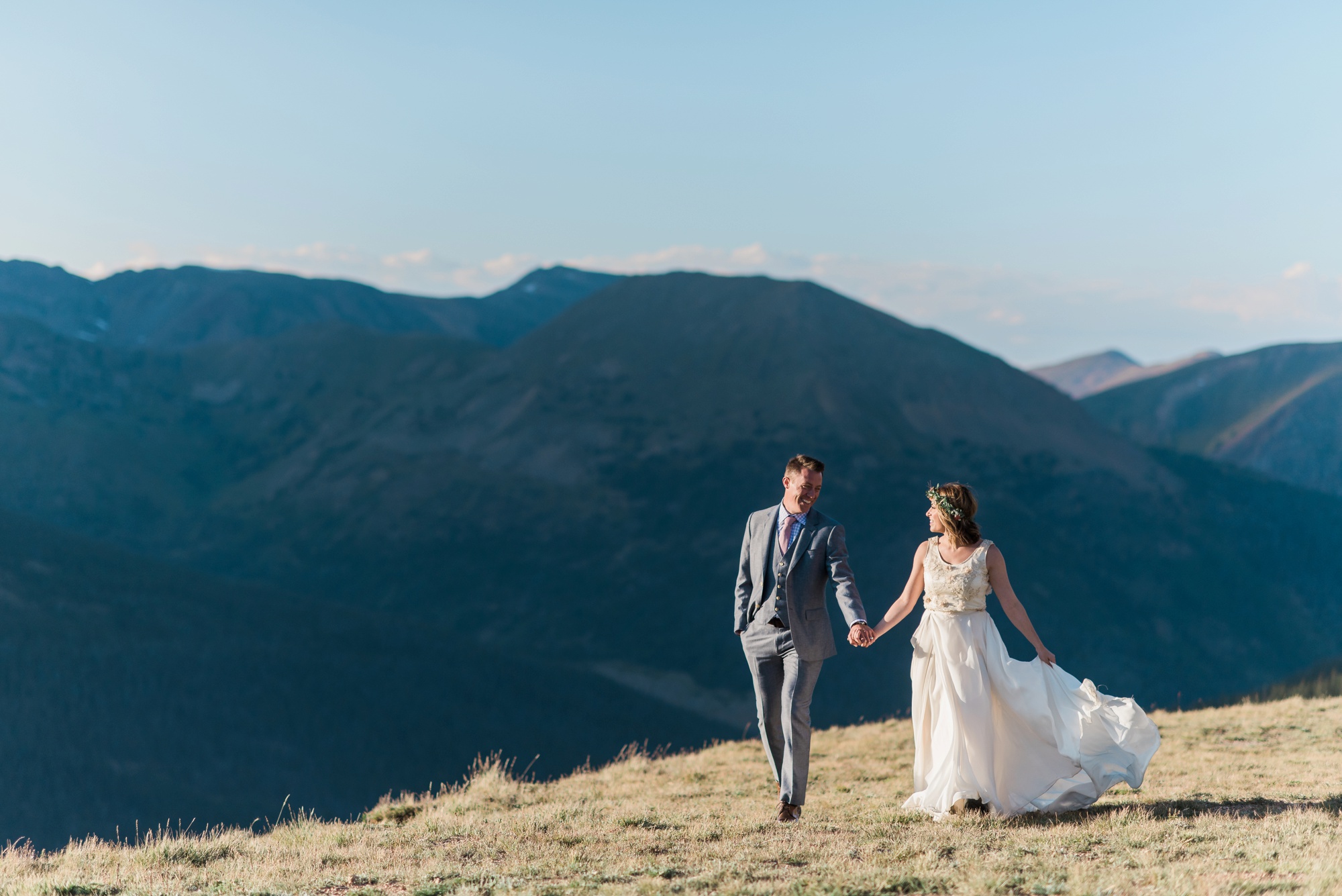 Strolling on a mountain pass in the Rocky Mountains holding hands with the love of your life while the sunshines warm on your wedding day