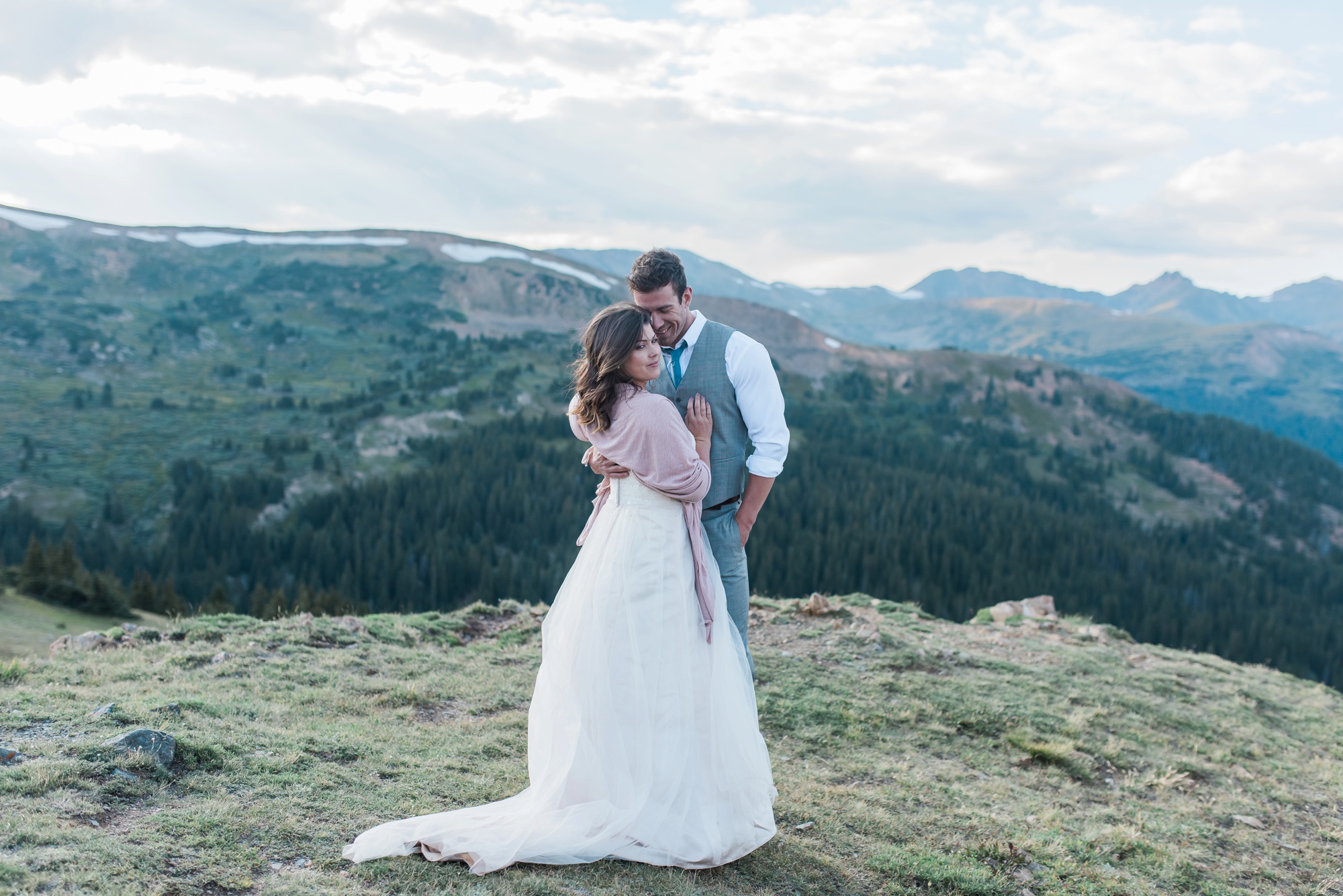 Newly married couple enjoying the beautiful mountain views during their intimate mountain top wedding