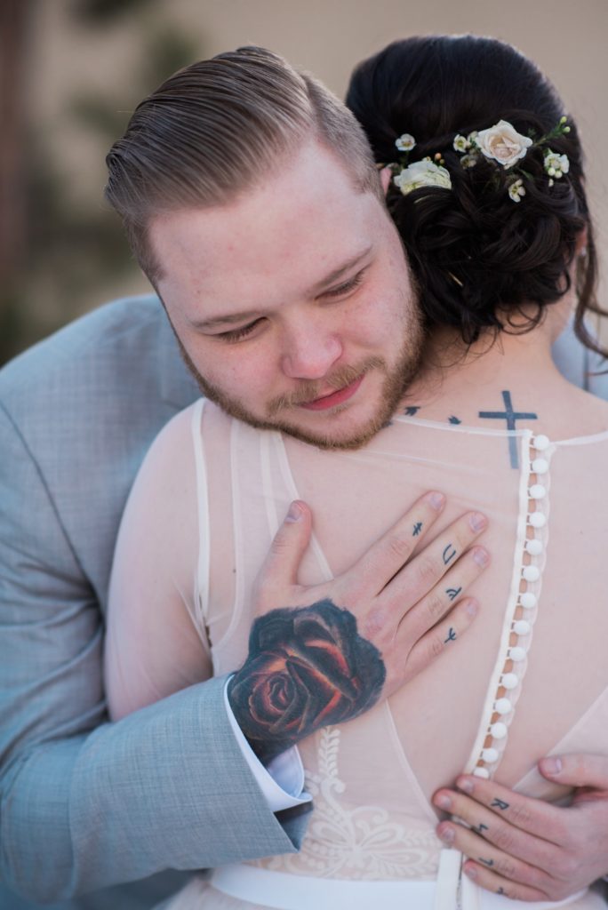 teary eyed groom stunned by bride's beauty during first look in Colorado 
