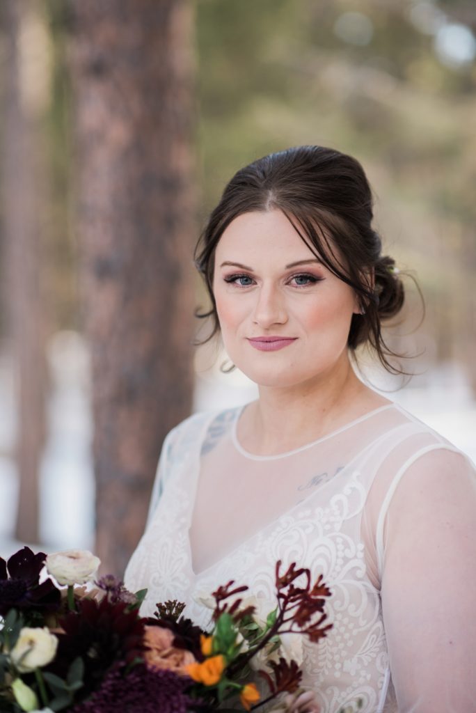 Bride holds her bouquet during her winter wedding at Black Forest by Wedgewood Wedding