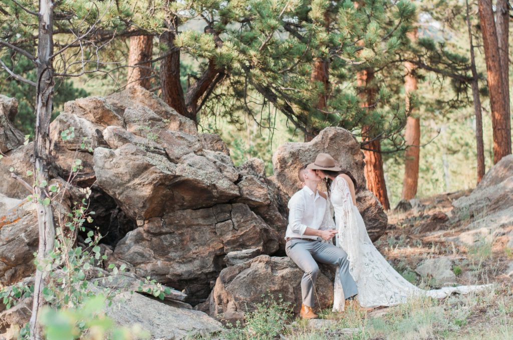 Couple pose near rock outcropping on private land for intimate ceremony