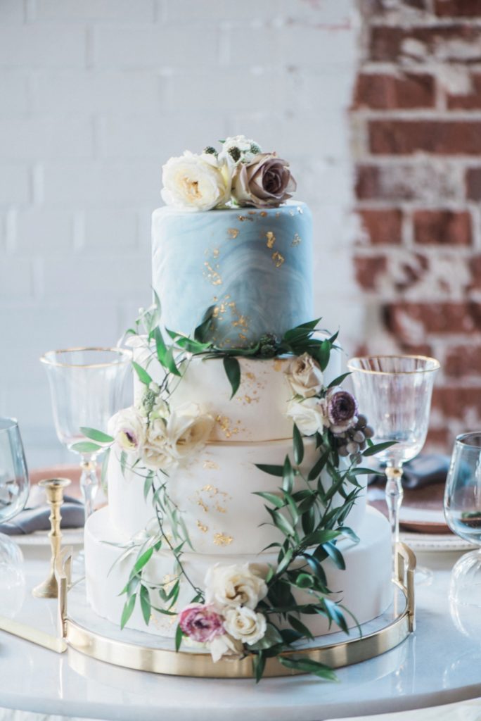 three tiered watercolor wedding cake with floral crown at Moss | Denver