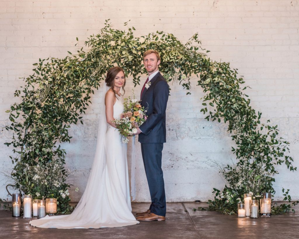 couple smiling at altar in Moss | Denver's gorgeous industrial ceremony room 