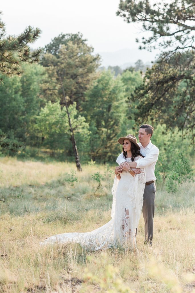 boho bride with groom on private estate embrace after ceremony 