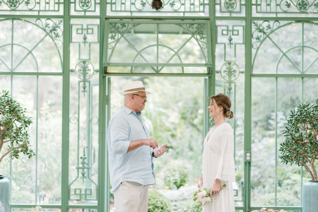 exchanging vows inside the Denver Botanic Gardens Solarioum one of the best wedding venues in Denver 