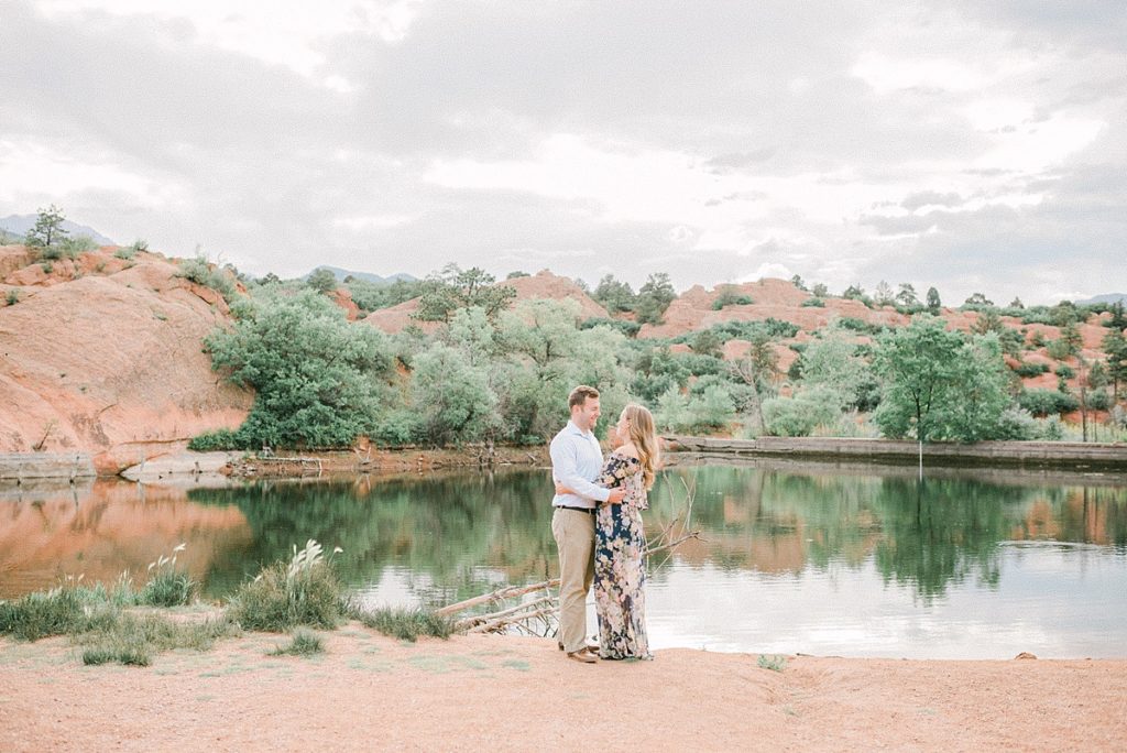 Couple embrace along the lake shore with Vail Wedding Photographer Jenna Wren  