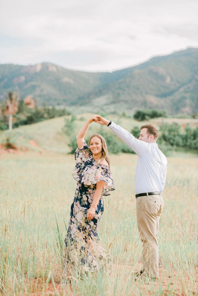 Couple slow dancing in the field at the base of the Rocky Mountains in Colorado with Vail Wedding Photographer Jenna Wren 