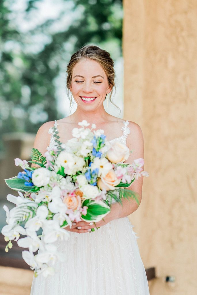 bride smiles with joy during summer wedding at Colorado wedding venue