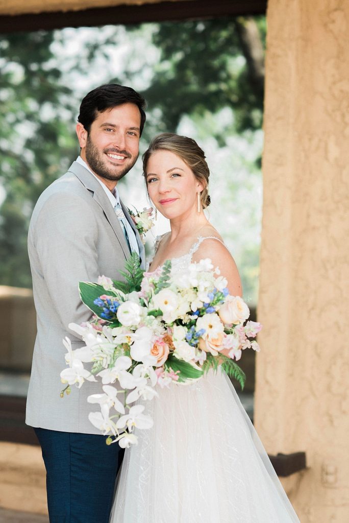 gorgeous bride and groom with orchid bouquet at summer wedding at Villa Parker