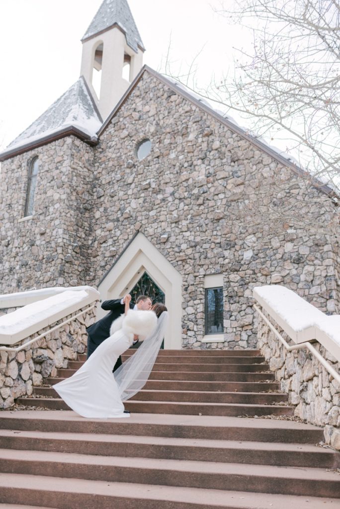 couple kiss outside the chapel at beaver creek