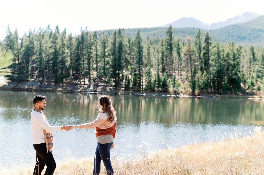 couple dancing on the lakeshore right after a surprise proposal in Colorado 