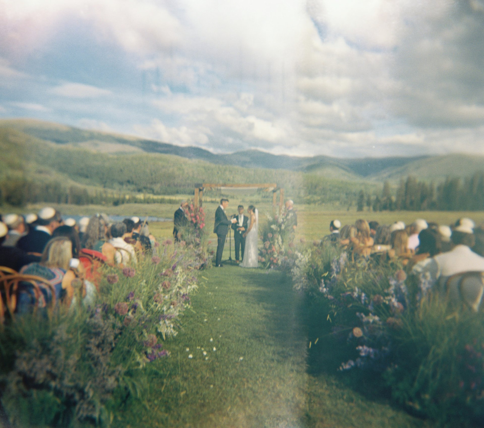 wedding ceremony at Devil's Thumb Ranch in Colorado on holga film
