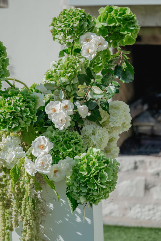 Outdoor wedding ceremony at The Arlo with modern black-and-white design and sleek floral aisle arrangements.