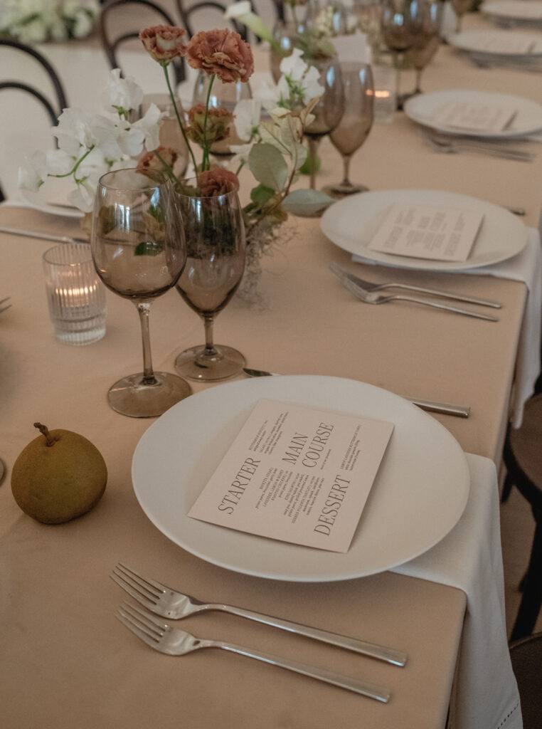 Outdoor wedding ceremony at The Arlo with modern black-and-white design and sleek floral aisle arrangements.