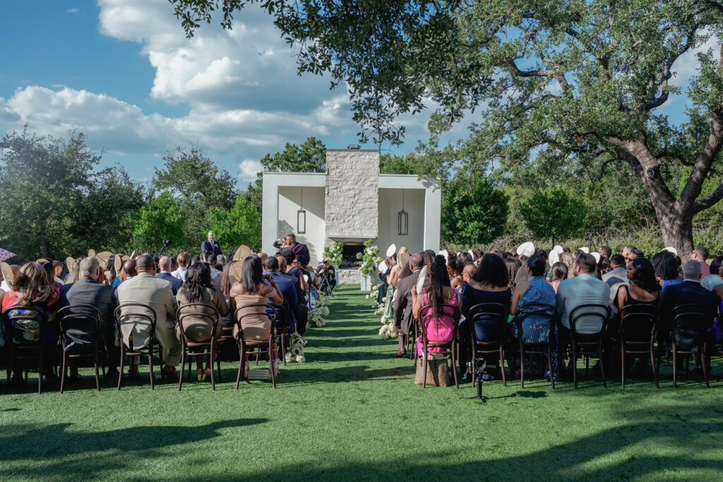 Outdoor wedding ceremony at The Arlo with modern black-and-white design and sleek floral aisle arrangements.