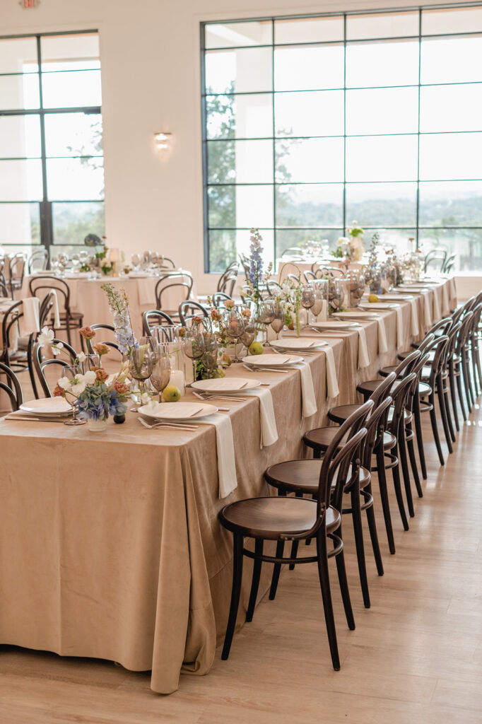 Timeless reception tablescape with minimalist white florals, candlelight, and modern place settings at The Arlo wedding venue.