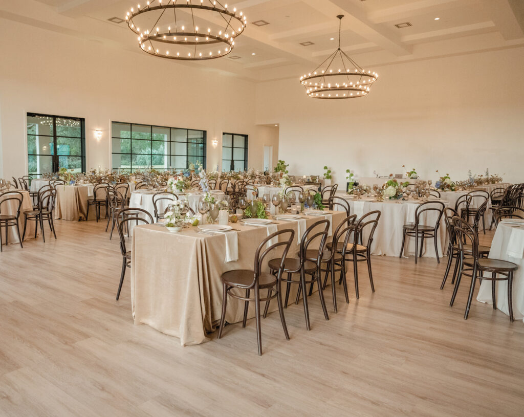 Timeless reception tablescape with minimalist white florals, candlelight, and modern place settings at The Arlo wedding venue.