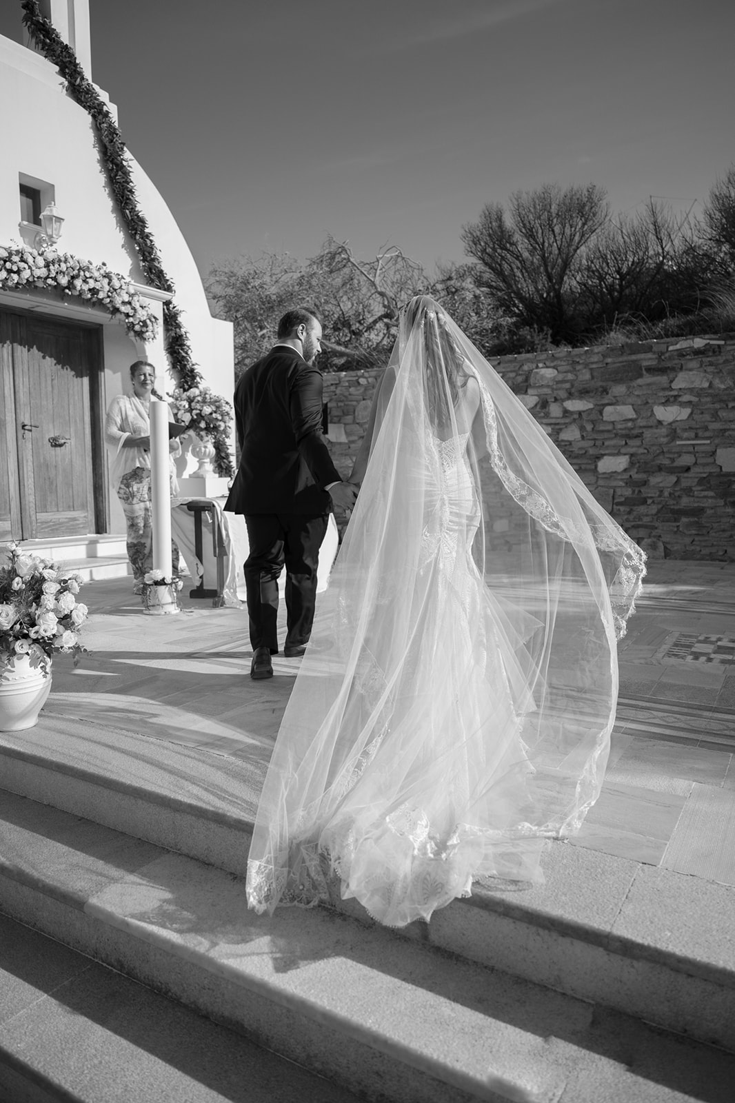 Faye and John walking through their Antiparos villa before their Greece wedding